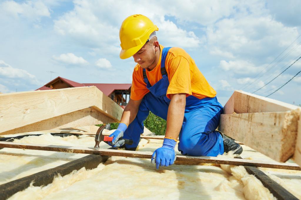 Good Vibes Roofing and Siding Inc. Images - Man drilling in tile roofing shingles