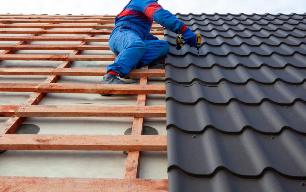 Good Vibes Roofing and Siding Inc. Images - Man drilling in tile roofing shingles